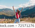 Young woman in Sochi with mountain view on the background, Russia. 72571276