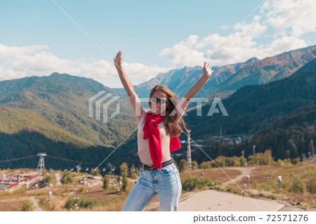 Young woman in Sochi with mountain view on the background, Russia. 72571276