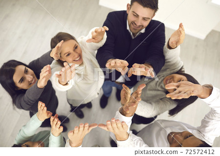 Business people raising hands up in air, illustrating concept of team aspiring for success Business people raising hands up in air, illustrating concept of team aspiring for success 72572412