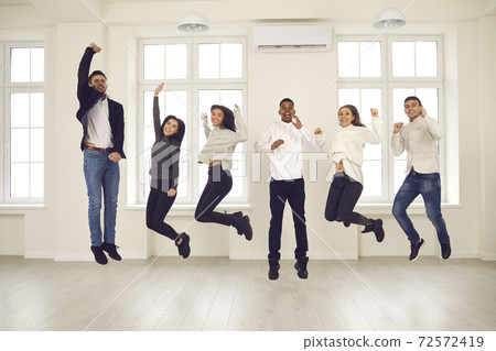 Group of happy energetic colleagues or friends jumping all together and celebrating success Group of happy energetic colleagues or friends jumping all together and celebrating success 72572419