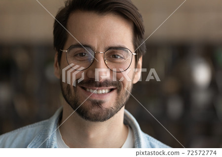 Portrait of smiling millennial man in glasses 72572774