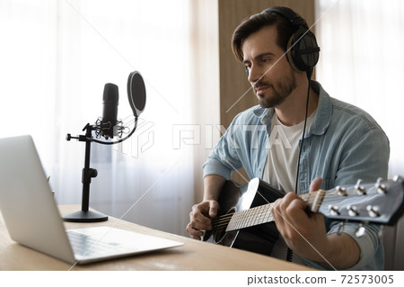 Young male artist learn playing guitar online Young male artist learn playing guitar online 72573005