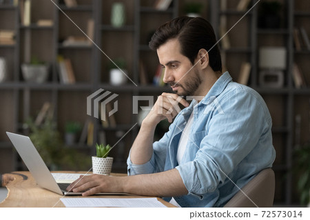 Pensive Caucasian man work on computer thinking 72573014