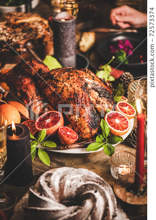 Holiday table with roasted turkey, chocolate cake Holiday table with roasted turkey, chocolate cake 72573374