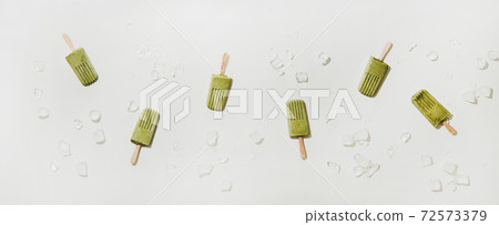 Flat-lay of homemade green matcha coconut Flat-lay of homemade green matcha coconut 72573379
