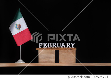 Wooden calendar of February with Mexico flag on black background. Holidays of Mexico in February 72574721