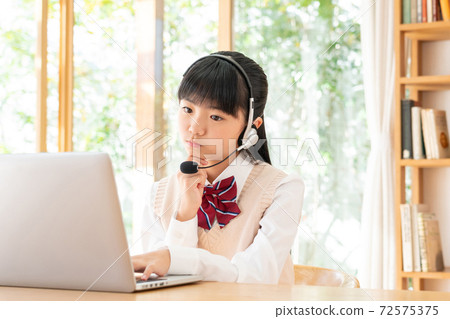 Junior high school girl studying in online class Junior high school girl studying in online class 72575375