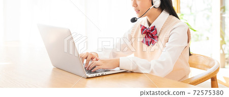 Junior high school girl studying in online class Junior high school girl studying in online class 72575380