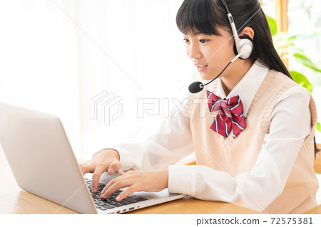 Junior high school girl studying in online class Junior high school girl studying in online class 72575381