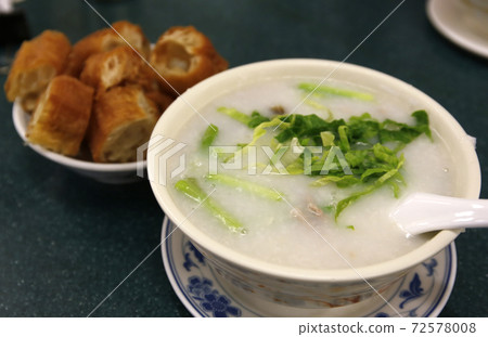 Cantonese porridge in Hong Kong. The back is a fried bread called Youtiao Cantonese porridge in Hong Kong. The back is a fried bread called Youtiao 72578008