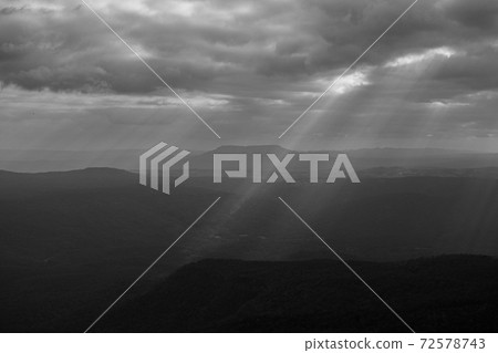 Sunset sky wide mountain landscape with ray of light at Pha Yieb Mek in Phu Kradueng National park. Thailand. Black and white 72578743