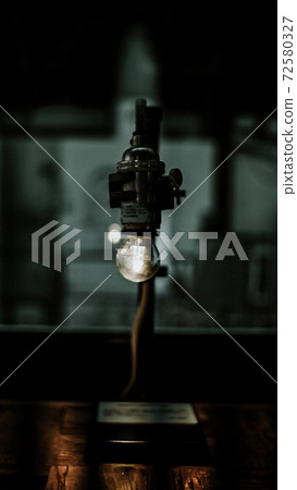 Serious light bulb figurine 72580327