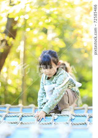 Girls playing in the park 72585466