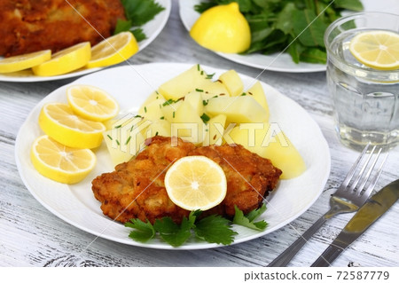 Wiener schnitzel and boiled potatoes Wiener schnitzel and boiled potatoes 72587779