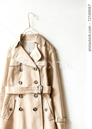 Light beige trench coat and white background Light beige trench coat and white background 72589067