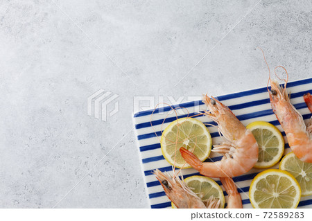 Cooked tiger prawns on striped plate Cooked tiger prawns on striped plate 72589283