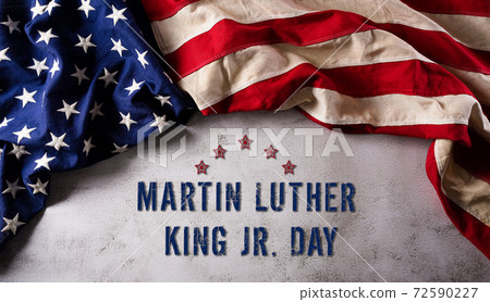 Martin Luther King Day anniversary concept. American flag against dark stone background Martin Luther King Day anniversary concept. American flag against dark stone background 72590227
