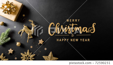 Christmas and new year background concept. Top view of Christmas gift box, spruce branches, pine cones, reindeer, christmas ball and snowflake on black wooden background. Christmas and new year background concept. Top view of Christmas gift box, spruce branches, pine cones, reindeer, christmas ball and snowflake on black wooden background. 72590231