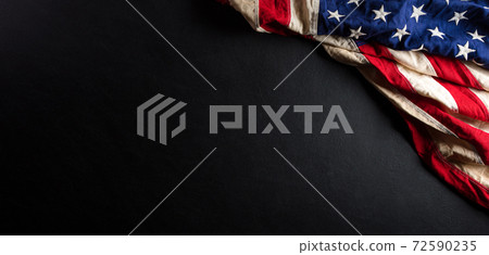 Martin Luther King Day anniversary concept. American flag against black wooden background 72590235
