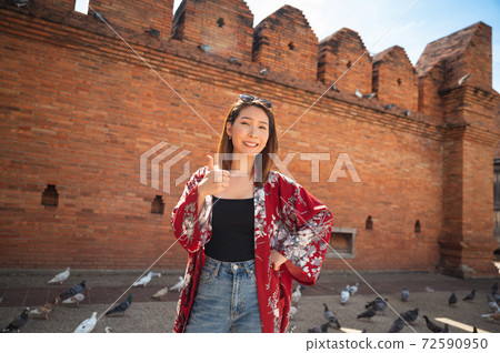 Asian woman traveling at Tha Phae Chiangmai old city wall in northern Thailand 72590950