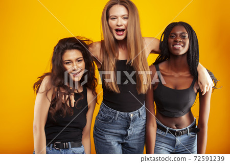 diverse multi nation girls group, teenage friends company cheerful having fun, happy smiling, cute posing on yellow background, lifestyle people concept, african-american, asian and caucasian diverse multi nation girls group, teenage friends company cheerful having fun, happy smiling, cute posing on yellow background, lifestyle people concept, african-american, asian and caucasian 72591239