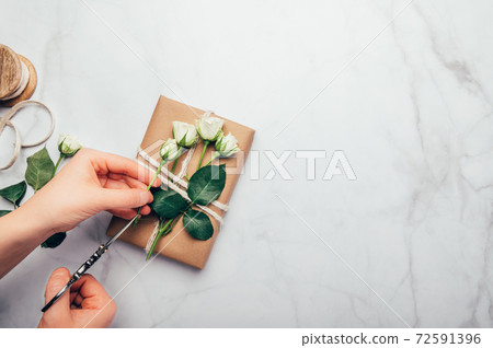 Eco friendly gift wrapped in brown paper Eco friendly gift wrapped in brown paper 72591396