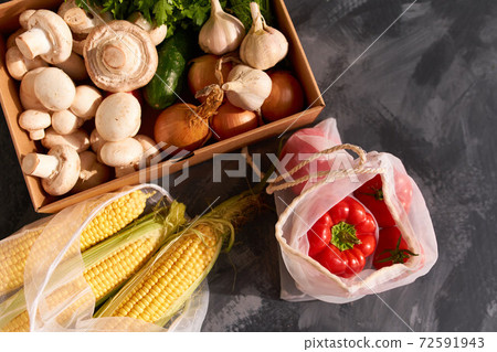 Fresh fruits and vegetables in reusable shopping bags. 72591943