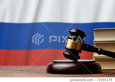 Justice and court concept in Russian Federation. Judge hammer on a flag background Justice and court concept in Russian Federation. Judge hammer on a flag background 72593176