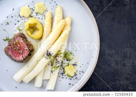 Modern design German barbecue dry aged sliced fillet steak with white asparagus Modern design German barbecue dry aged sliced fillet steak with white asparagus 72593433