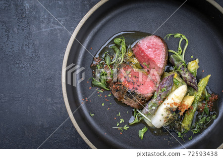 German asparagus potato salad with barbecue dry aged sliced fillet steak 72593438