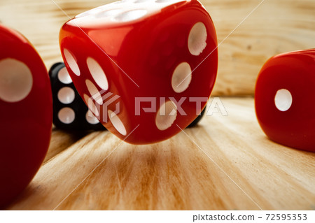 Red and black dice cubes on wooden background Red and black dice cubes on wooden background 72595353