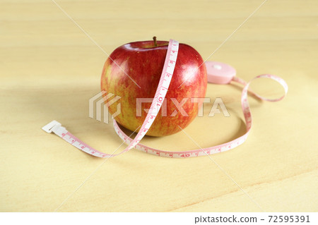 Apple wrapped with a tape measure 2 Apple wrapped with a tape measure 2 72595391