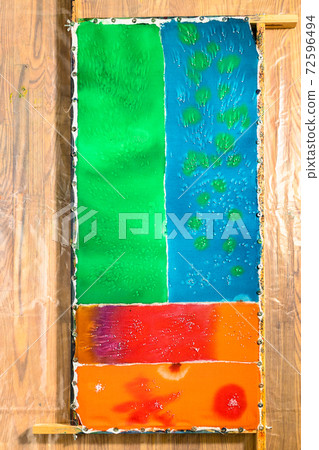 top view colored cloth in batik technique on frame top view colored cloth in batik technique on frame 72596494