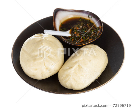 Wang Mandu Pyanse on brown plate served with sauce 72596719