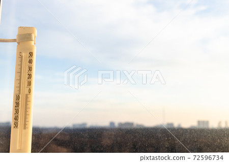 outdoor thermometer on window lit by sunrise sun outdoor thermometer on window lit by sunrise sun 72596734