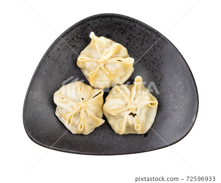 top view of steamed Buuz on black plate isolated top view of steamed Buuz on black plate isolated 72596933