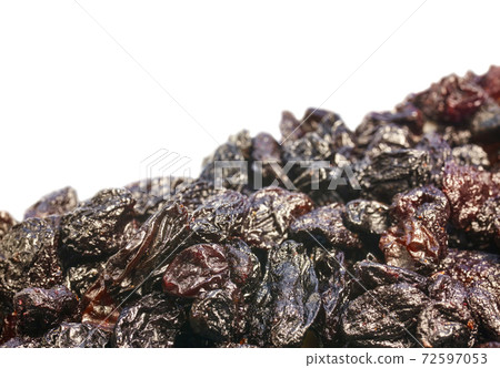 Extreme close up picture of small seedless raisins isolated on white background. Extreme close up picture of small seedless raisins isolated on white background. 72597053