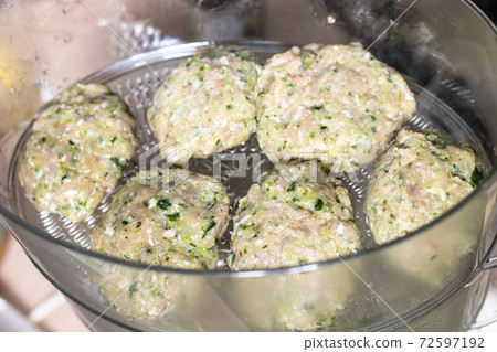 above view of chicken cutlets in electric steamer above view of chicken cutlets in electric steamer 72597192