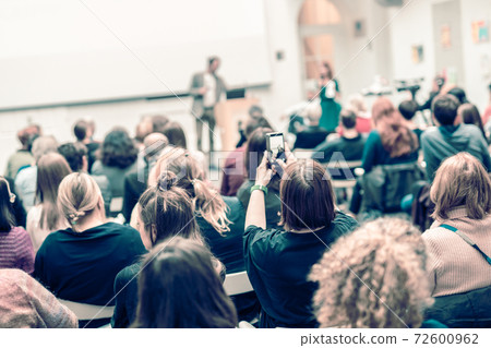 Man giving presentation in lecture hall at university. Man giving presentation in lecture hall at university. 72600962
