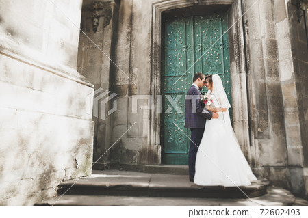 Gorgeous wedding couple walking in the old city of Lviv 72602493