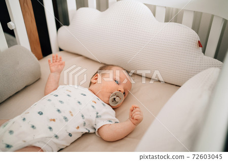 View top. The infant is in the crib. organizing a place for children's sleep. View top. The infant is in the crib. organizing a place for children's sleep. 72603045