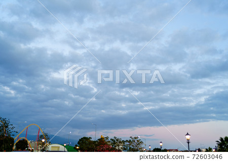 sunset dark sky rolled with clouds above the resort town. faith in God. sunset dark sky rolled with clouds above the resort town. faith in God. 72603046
