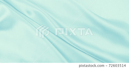 Smooth elegant blue silk or satin luxury cloth texture as abstract background. Luxurious background design 72603514