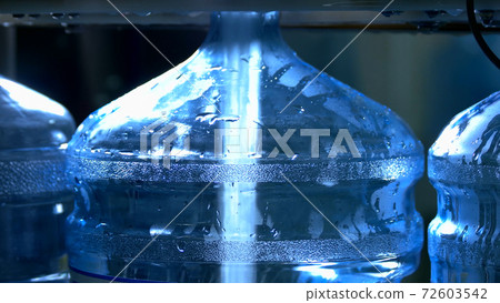 Bottle being filled with water. 72603542