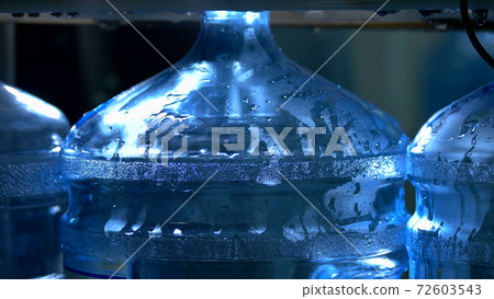 Bottle being filled by water. 72603543