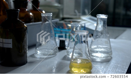 Lab flasks with chemical liquid. Lab flasks with chemical liquid. 72603554