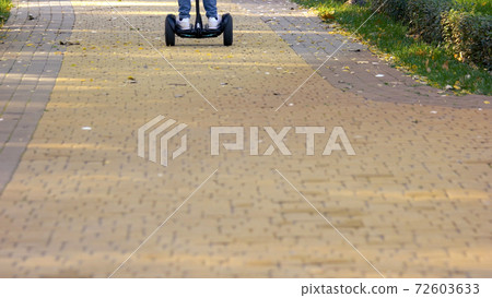 Boy riding gyroscooter outdoors. Boy riding gyroscooter outdoors. 72603633