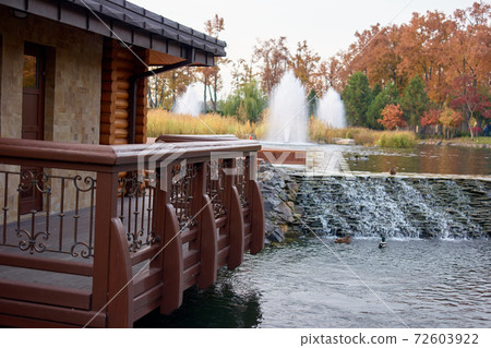 Wooden balcony upon a pond water. Wooden balcony upon a pond water. 72603922