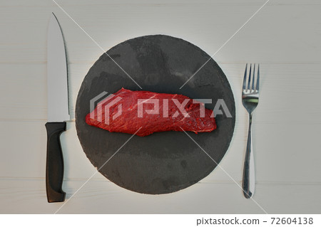 Red fresh raw beef veal fillet on a plate. 72604138