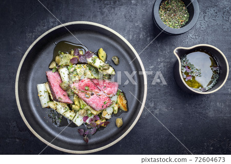 dry aged sliced filet steak with asparagus potato salad 72604673